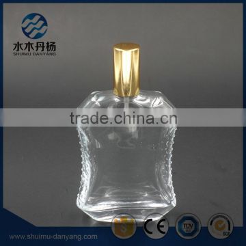 Fancy 50ml unique shaped perfume glass bottle with golden spray                        
                                                                                Supplier's Choice