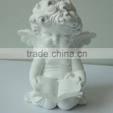 Angel statue concentrate on reading the Bible book decoration for church