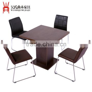 Square wooden table and leather chairs