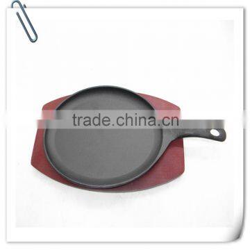 Red oval wooden base small frying pan