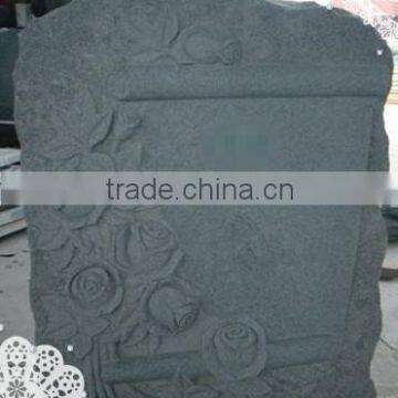 grey granite monument with flowers