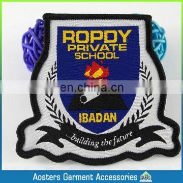 Die cut shape and black thread border over lock school woven badge for high school uniform