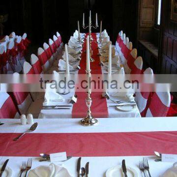 White polyester banquet chair covers with red sashes for wedding