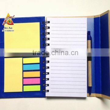 notebook with sticky notes and pen