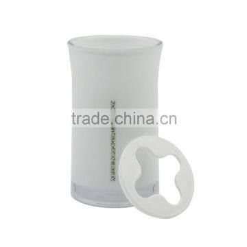 white toothpaste and toothbrush holder