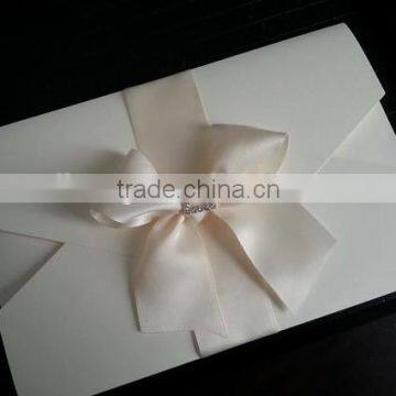 ivory double pocket fold ribbon and brooch wedding invitation card