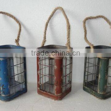 small metal lantern with rope handle and glass