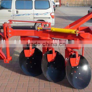 Farm Tractor driving reversible agricultural disc plough and disc plow