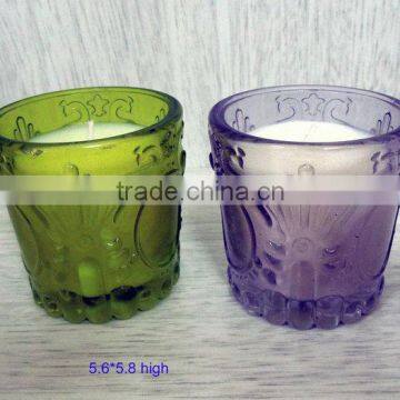 white candle in different color glass holder for christmas using, votive candles