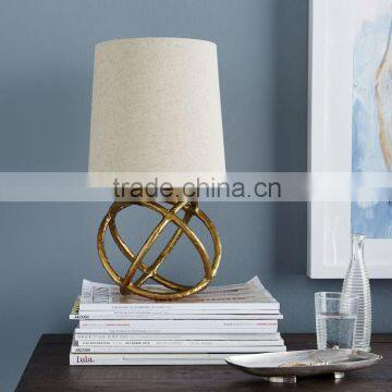 11.23-1 geometry inspired Brass beauty Mini Geodesic Table Lamp natural linen shade adds a warm glow beside sofas