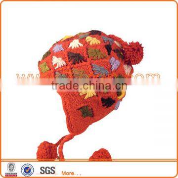 Knitted hat with top ball for girls