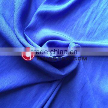 Woven technics women dress fabric dyed in elegant blue