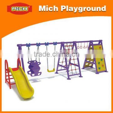 Playground with rock climbing wall slide and swing