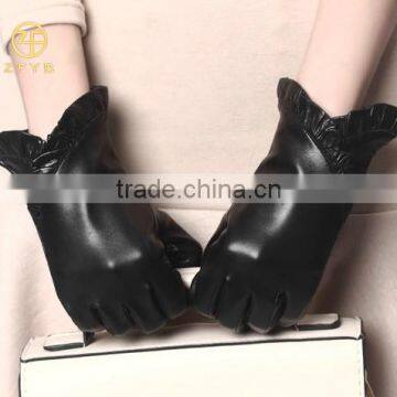 women black color lambskin putting on leather gloves