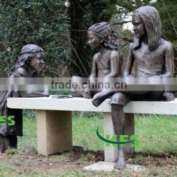 Bronze girls playing in yard sculpture