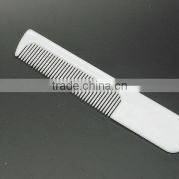 white plastic inflight comb