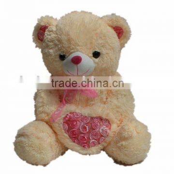 plush and stuffed bear with heart