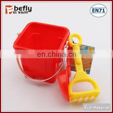 Red plastic mini sand bucket with shovel