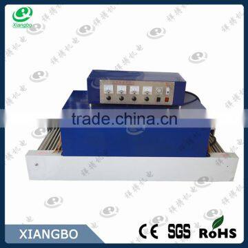 Shrink wrapping machine, shrink wrap machine, shrink packaging machine
