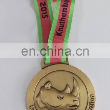 Triatlon Medal with a 3D rhino on the surface in antique gold plating and die cast process