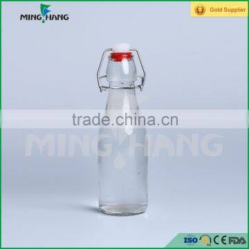 Clear beverage glass bottle with flip top