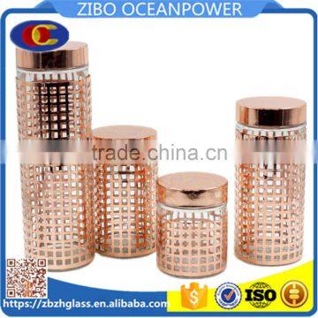 glass canister with gold embossing metal cover