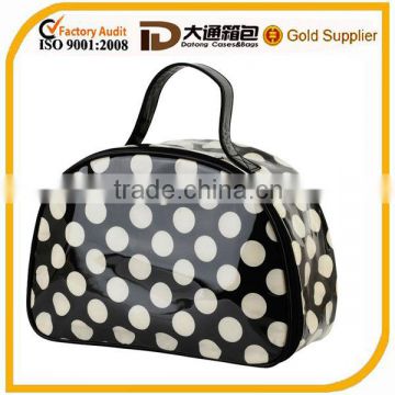 Lightweight clear coated cosmetic bag featuring an allover polka dot print