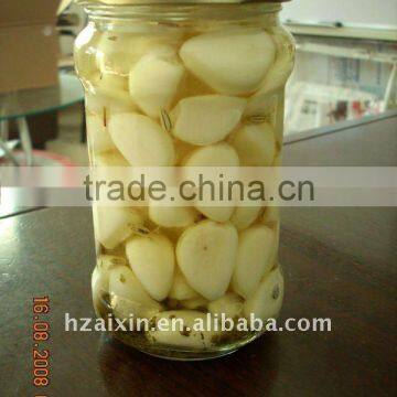 Peeled garlic cloves in glass jar