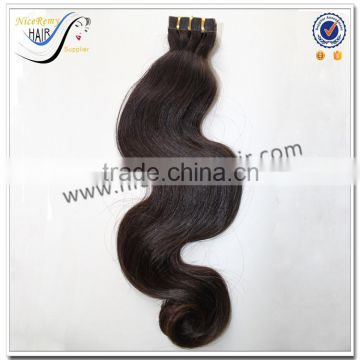 Wholesale grade 7a body wave natural color virgin indian hair curly tape hair extensions