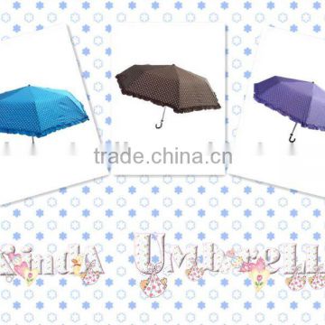 Beautiful lady folding umbrella