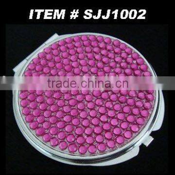 pink diamond-studded compact mirror