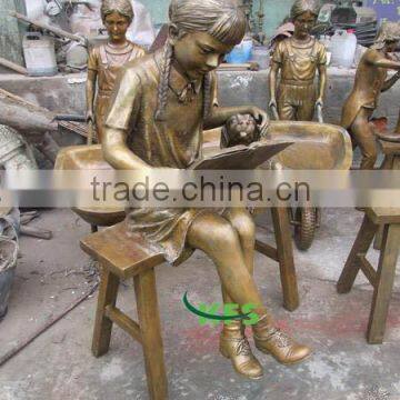 Bronze girl reading with dog sculpture