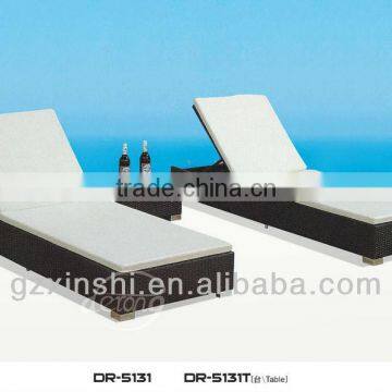 Outdoor black rattan beach chair with cushion and table