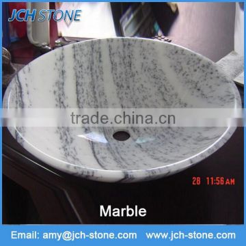 White marble stone round bathroom sink