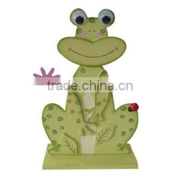 Easter Wooden frog decoration with flower on topdesk for home decorative