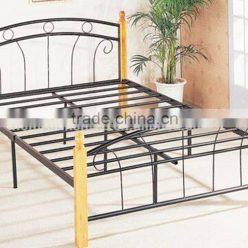 Antique double metal bed with wood legs