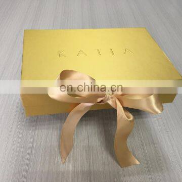 Very shiny gold printing flat rigid box with embossed logo match gold bow for gift packed