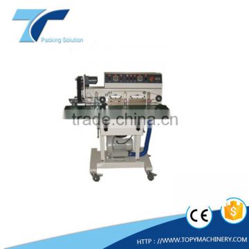 Horizontal continous band sealing machine with vacuum device