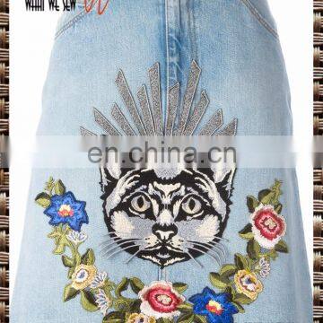 Light indigo cotton embroidered denim skirt from W.W.S. featuring a five pocket design