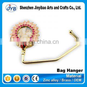 Custom design flower design diamond decorative luxurious metal polishing bag hanger hook