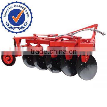 Farm Tractor driving reversible agricultural disc plough and disc plow