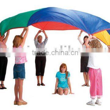 Beautiful children play rainbow parachute