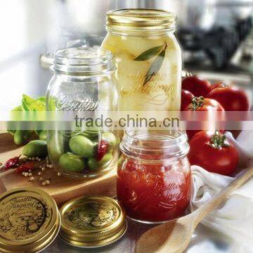 Glass storage jar with gold color metal lid