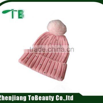 pink beanie with fur ball and cuff