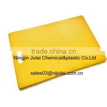 Abrasion and impact resistant food safe yellow UHMW-PE cutting board