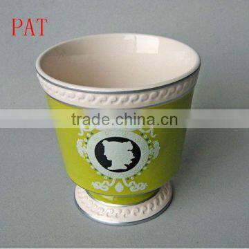 Stock ceramic flower pot in green color round shape