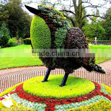 Colorful fake flowered topiary animal bird with iron wire mesh base