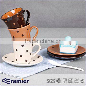 Stoneware conical coffee cup and saucer set with handpainted dots