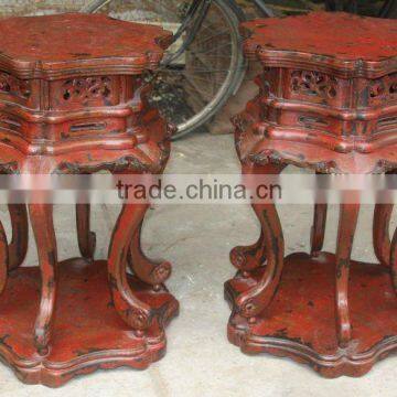 red wooden flower stool