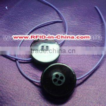 Button-Sized Industrial RFID Tags for Long Range Laundry Garment Tracking